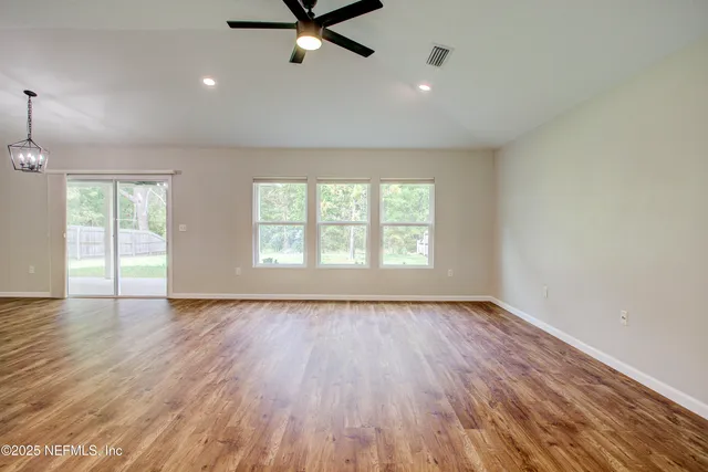 a kitchen with stainless steel appliances granite countertop a stove and white cabinets