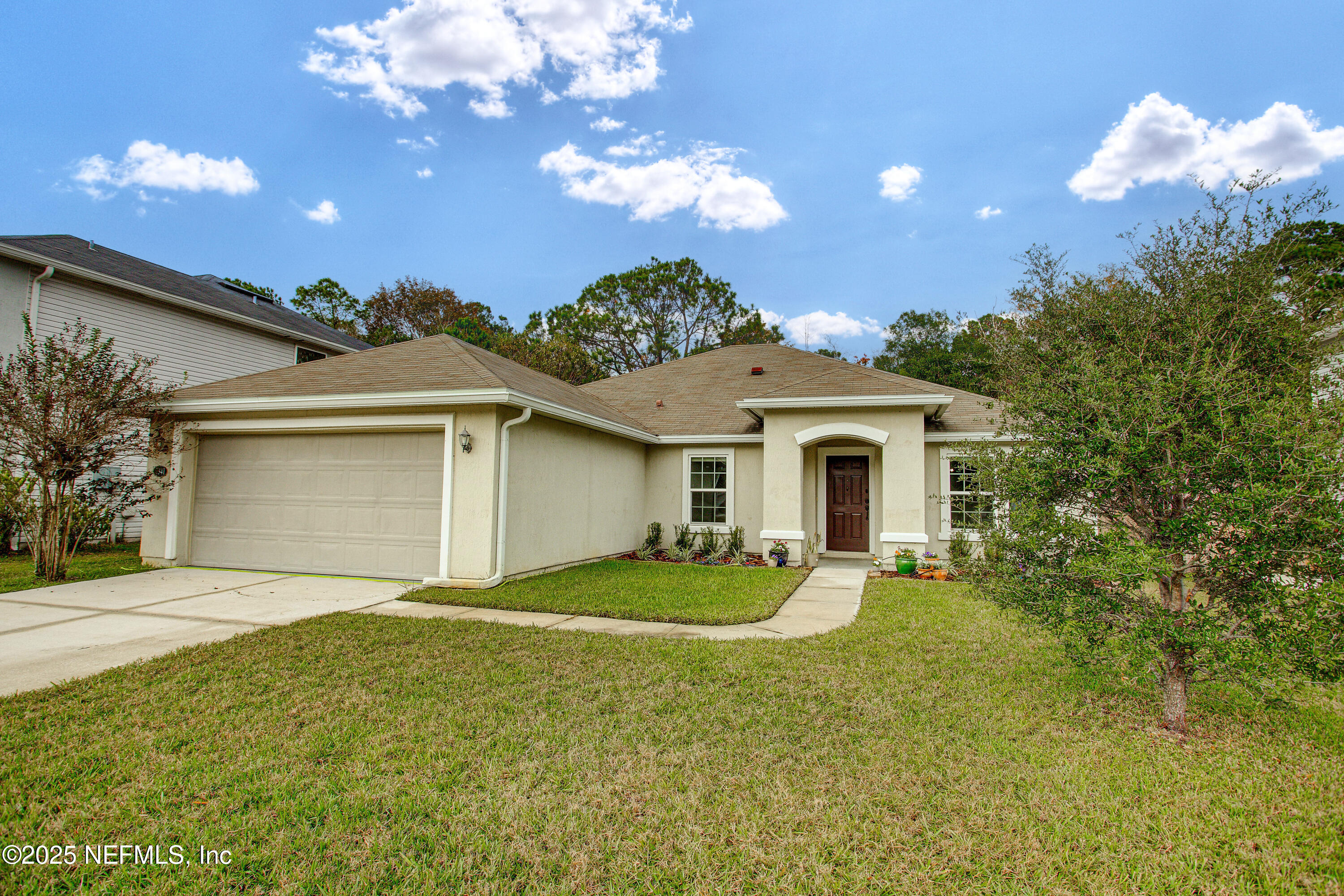 7341 Steventon Way Jacksonville, FL 32244 - Photo 2 of 75 a front view of a house with yard and outdoor seating