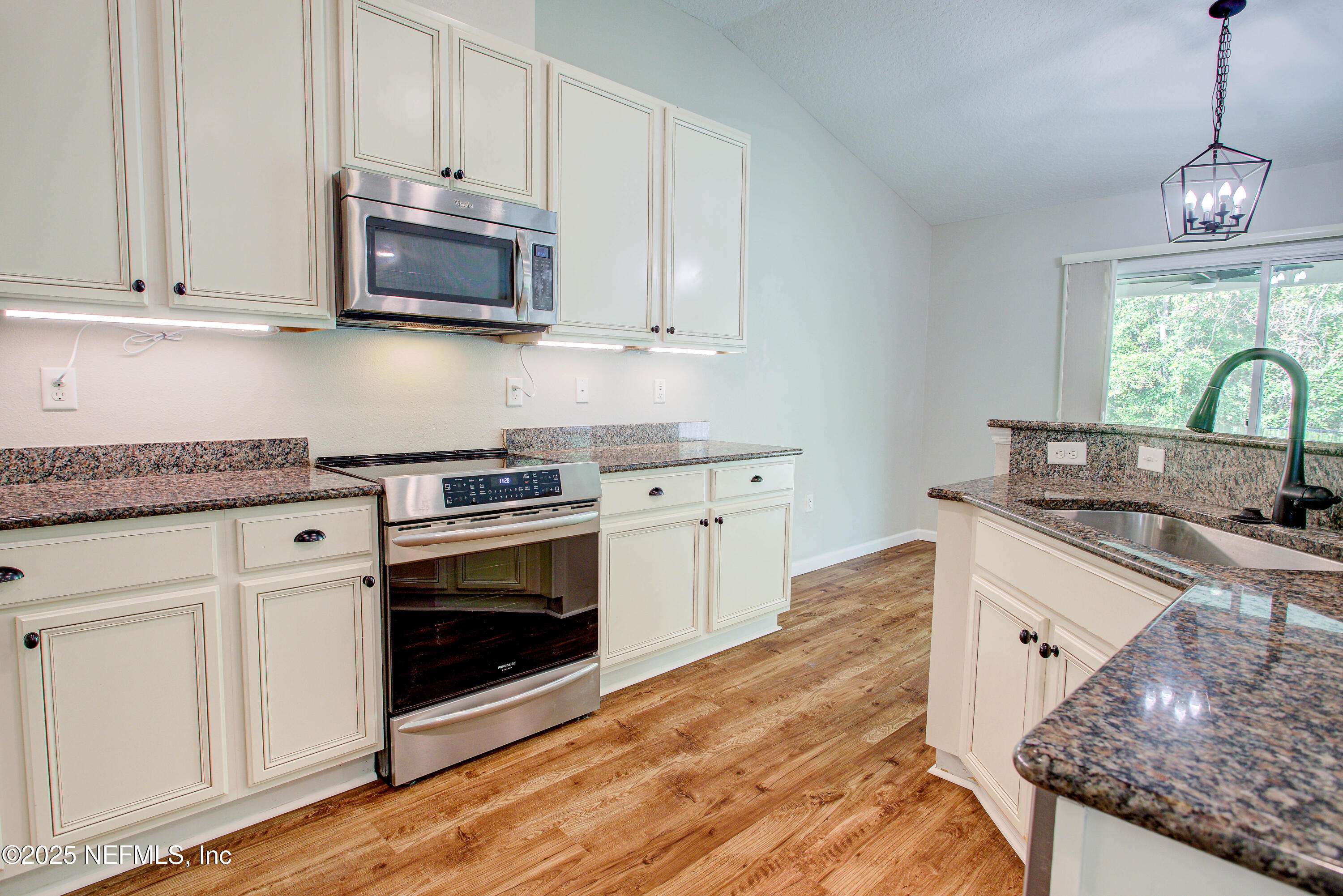 7341 Steventon Way Jacksonville, FL 32244 - Photo 21 of 75 a kitchen with stainless steel appliances granite countertop a stove a sink and a microwave