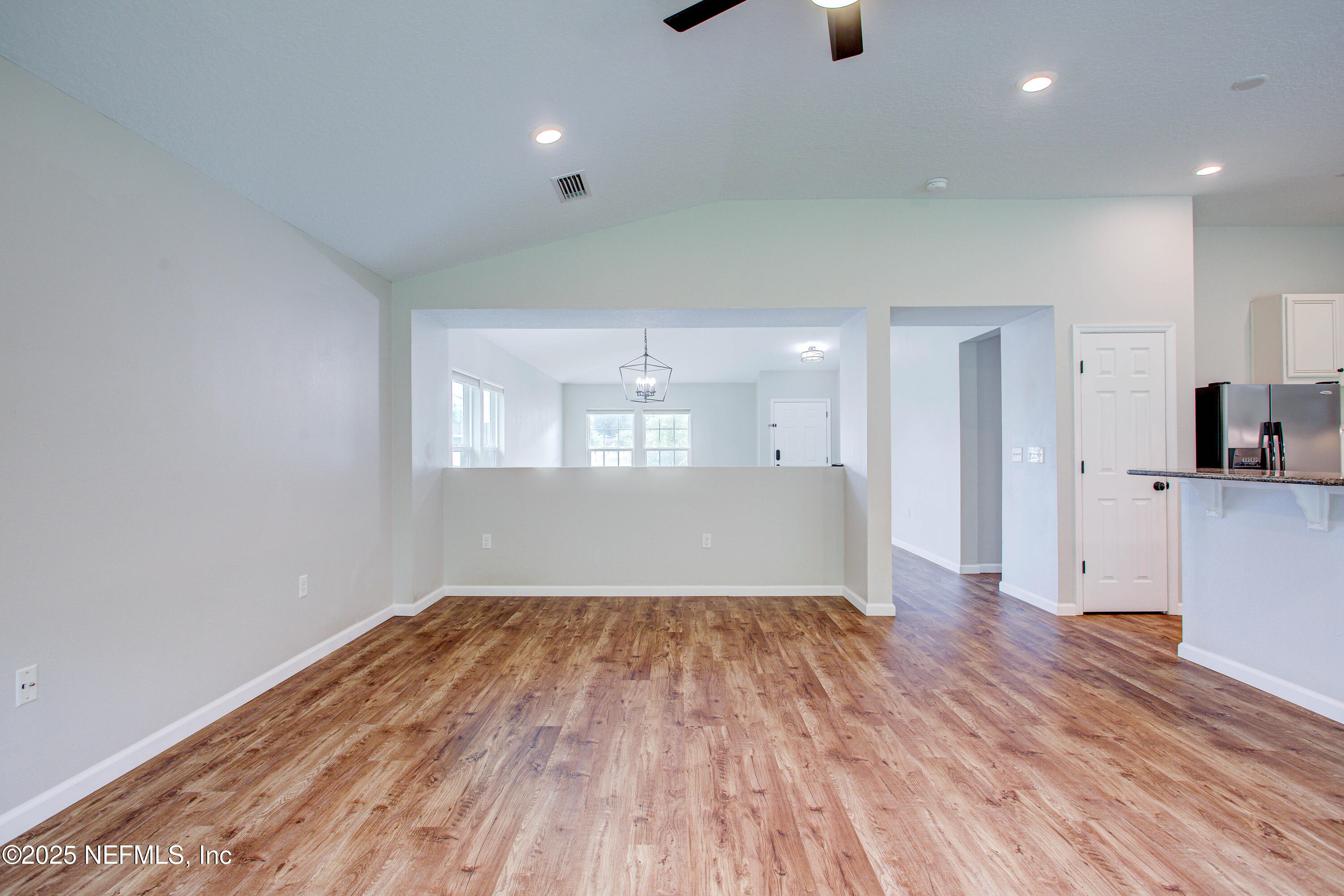 7341 Steventon Way Jacksonville, FL 32244 - Photo 30 of 75 a view of empty room with wooden floor and kitchen