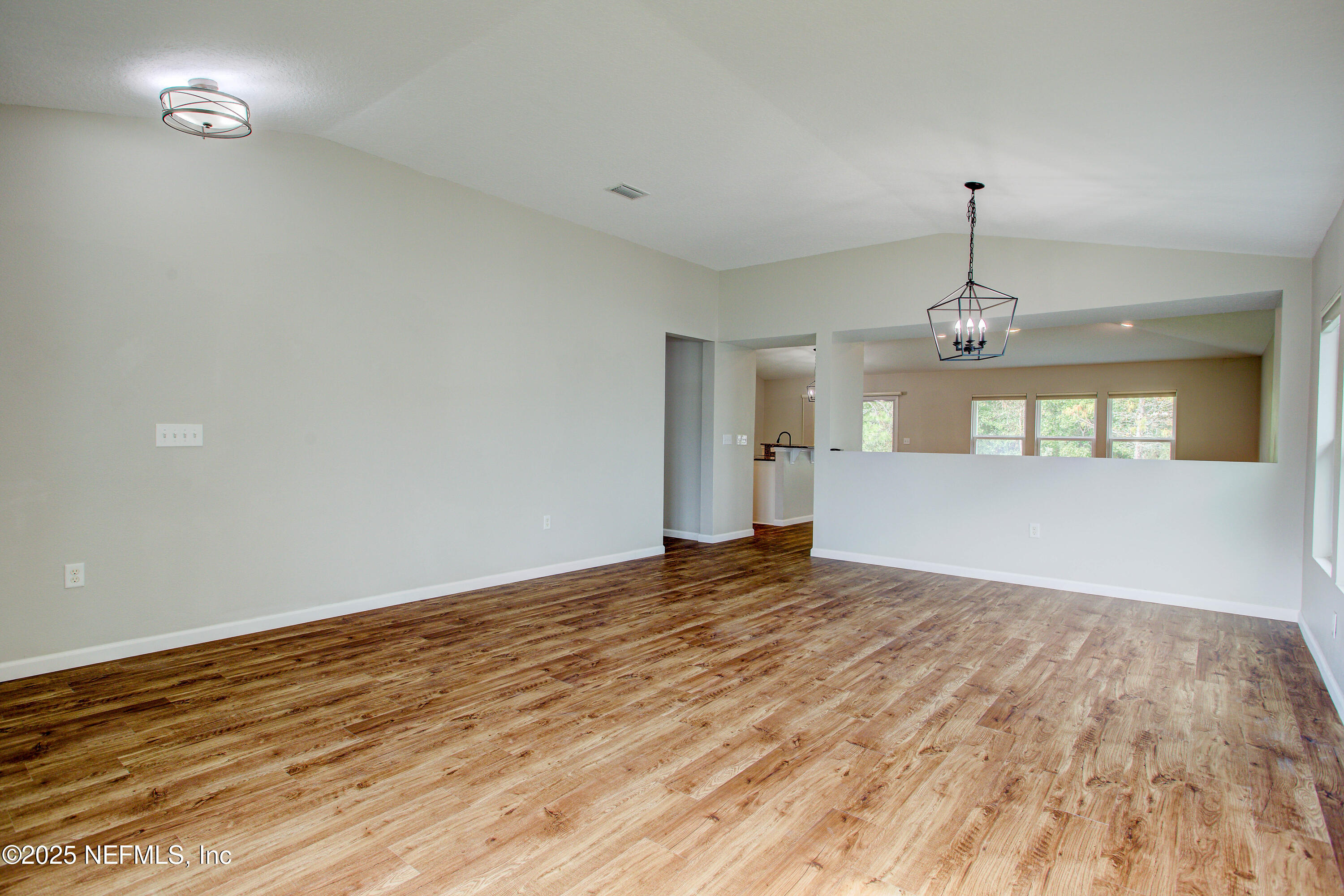 7341 Steventon Way Jacksonville, FL 32244 - Photo 10 of 75 wooden floor in an empty room with a window