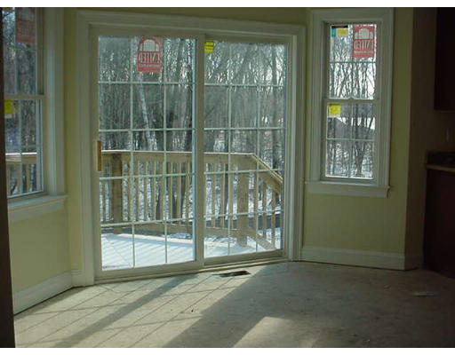 81 Higley Road Ashland, MA 01721 - Photo 4 of 16 a view of empty room with floor to ceiling windows