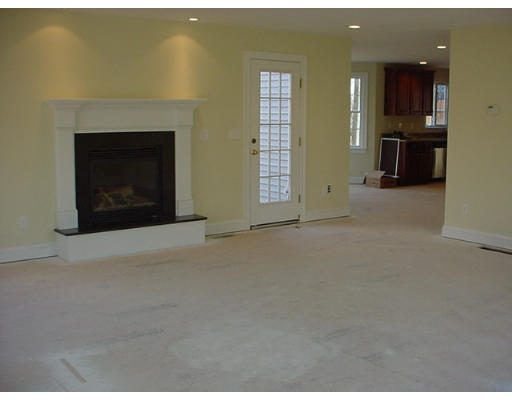 81 Higley Road Ashland, MA 01721 - Photo 5 of 16 a view of an empty room with a fireplace