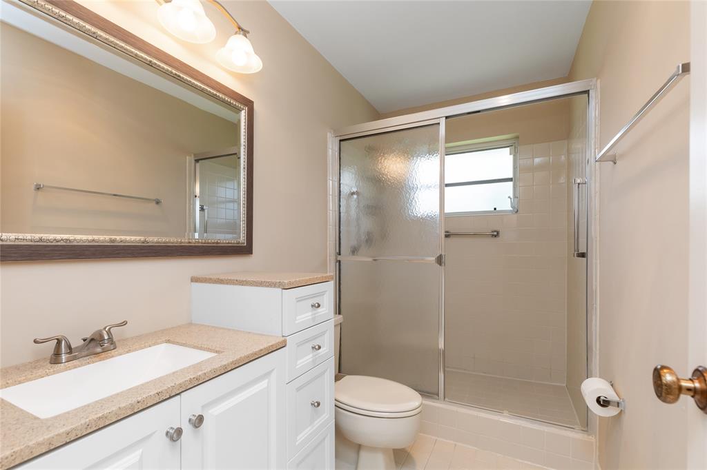 Undisclosed Address Boynton Beach, FL 33436 - Photo 14 of 16 a bathroom with a granite countertop sink toilet and shower