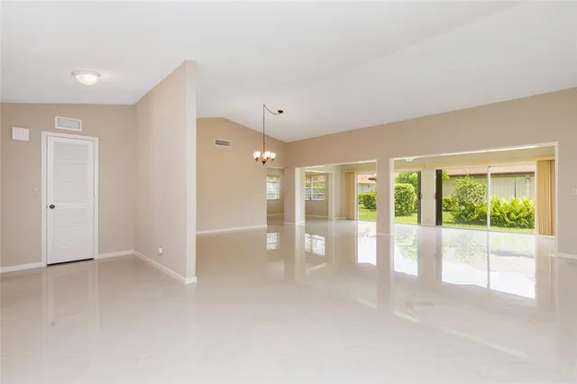 a view of an empty room with glass door