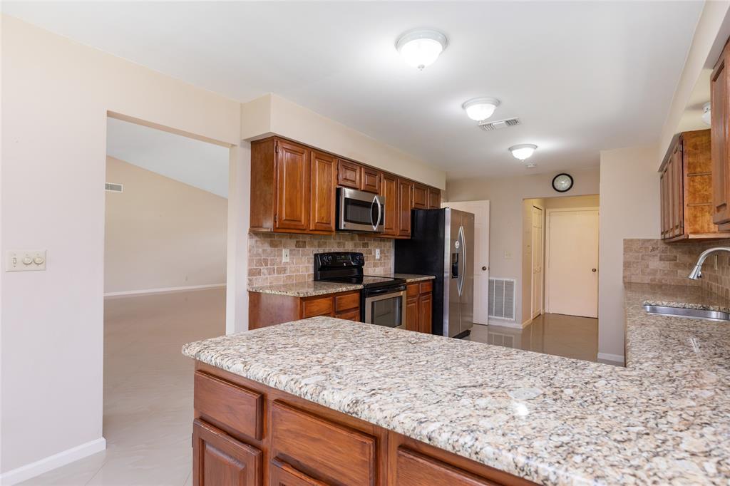 Undisclosed Address Boynton Beach, FL 33436 - Photo 5 of 16 a kitchen with stainless steel appliances kitchen island granite countertop a refrigerator and a sink