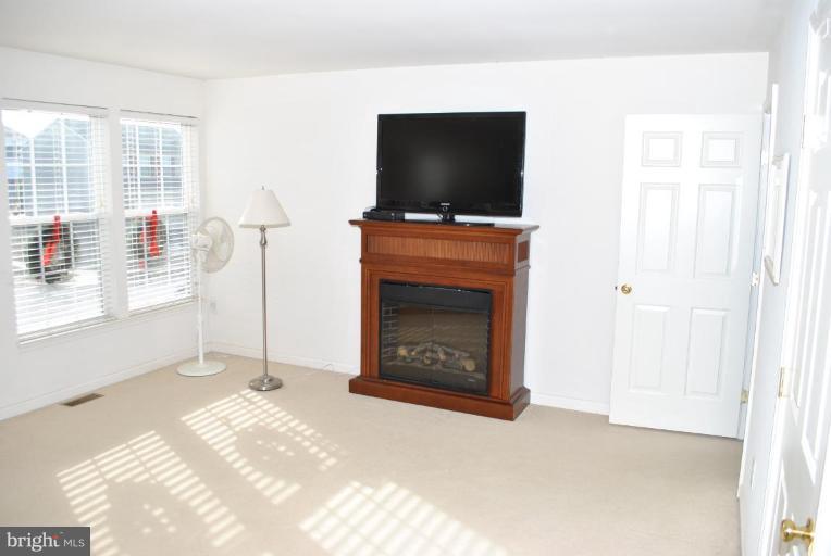 108 Stone Run Drive Rising Sun, MD 21911 - Photo 5 of 10 a view of an empty room with a fireplace and a flat screen tv