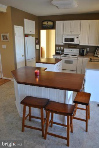 108 Stone Run Drive Rising Sun, MD 21911 - Photo 7 of 10 a kitchen with a table chairs sink and cabinets