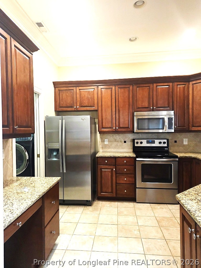 2671 Lockwood Road, Unit 202 Fayetteville, NC 28303 - Photo 7 of 32 a kitchen with stainless steel appliances granite countertop a refrigerator stove and oven