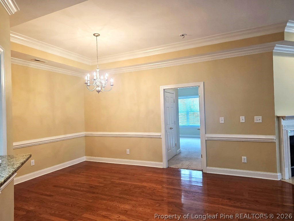 2671 Lockwood Road, Unit 202 Fayetteville, NC 28303 - Photo 9 of 32 a view of a room with wooden floor and chandelier