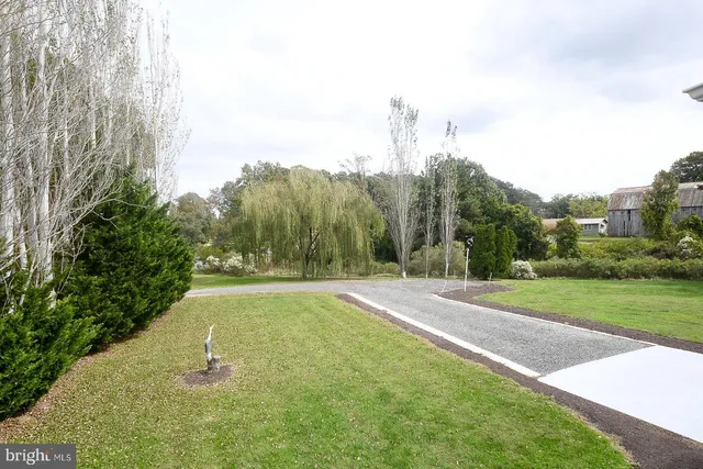 a kitchen with granite countertop a stove a sink and a microwave