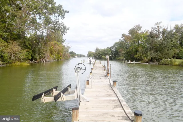 a kitchen with granite countertop a sink a counter space and stainless steel appliances