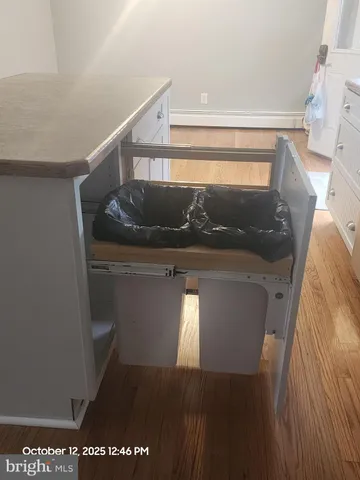 a view of an empty room and wooden floor