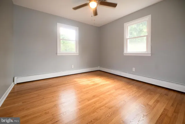 an empty room with closet and windows