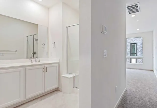 a bathroom with a double vanity sink toilet and a mirror
