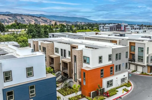 an aerial view of residential houses with outdoor space