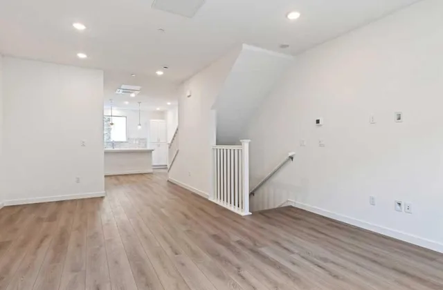 a view of empty room with wooden floor