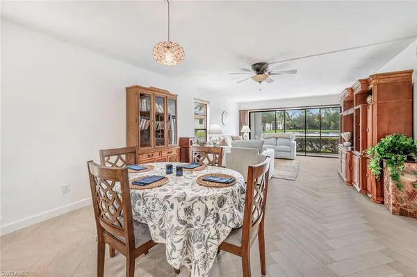 a dining room with furniture a window and a chandelier