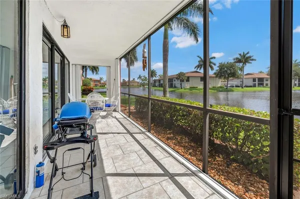 a view of a balcony with chairs and wooden floor