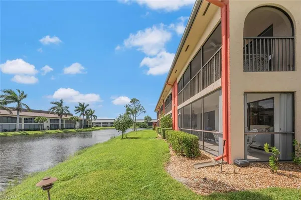 a view of a lake with houses in the back
