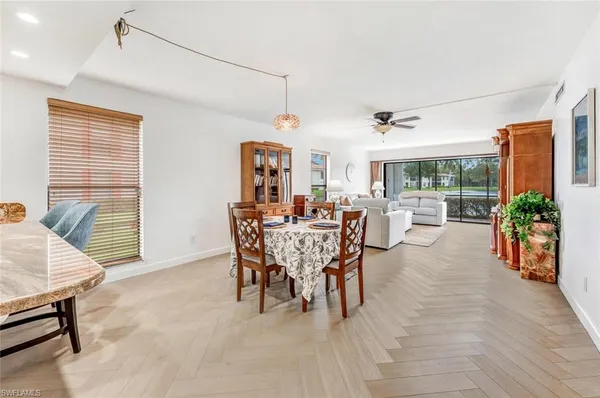 a view of a dining room with furniture and a potted plant