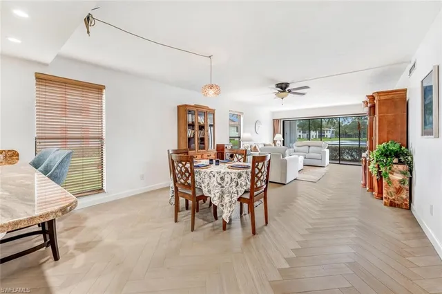 a view of a dining room with furniture and a potted plant