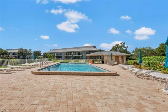 a view of swimming pool with outdoor seating and city view