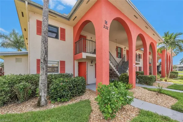 a front view of house with a garden