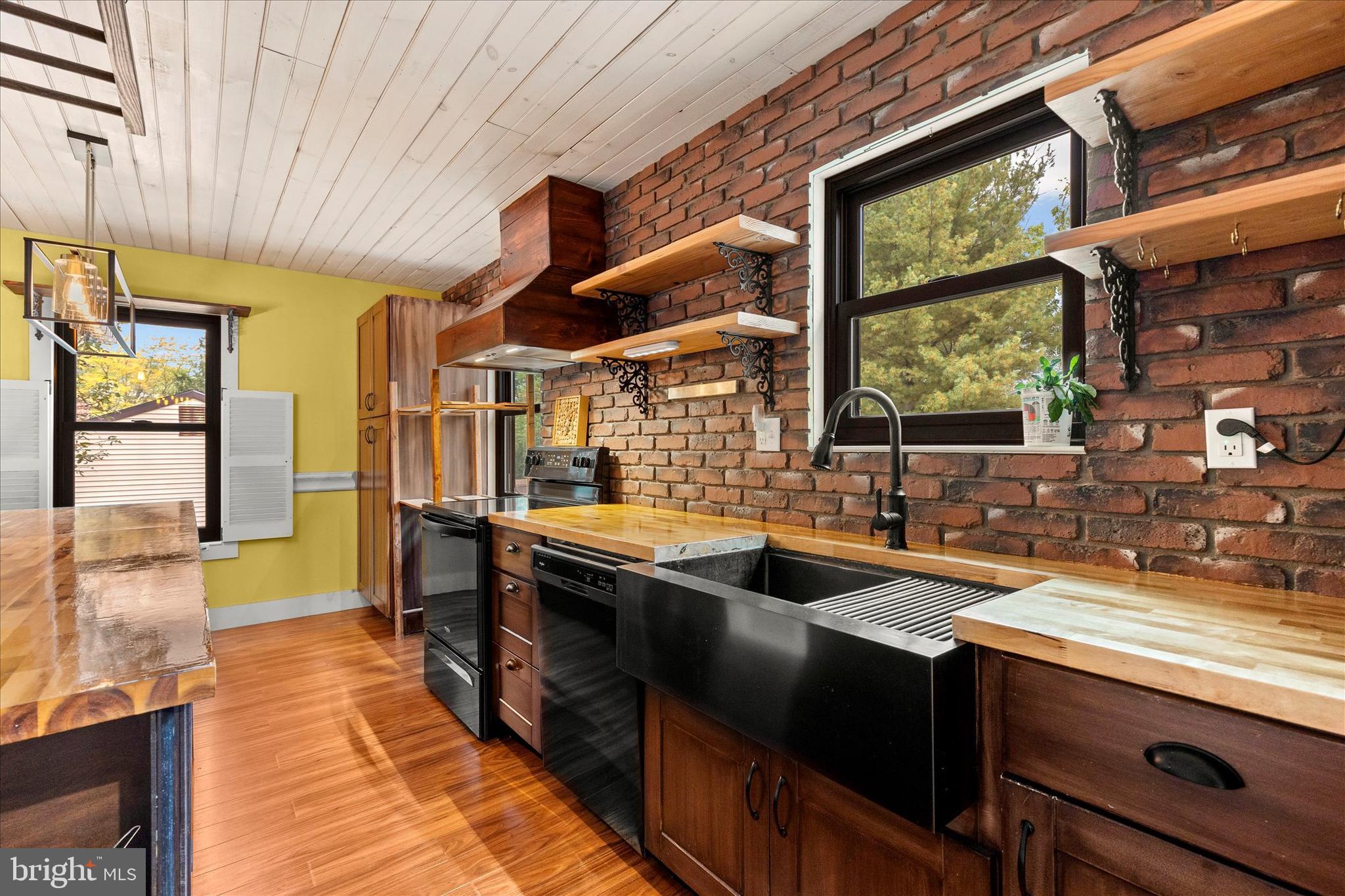 1769 Rainbow Circle York, PA 17408 - Photo 11 of 38 a kitchen with stainless steel appliances granite countertop sink stove and large window