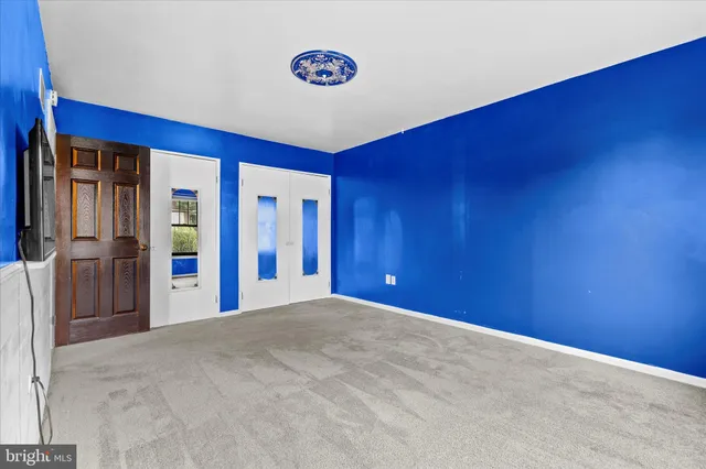 an empty room with windows and closet