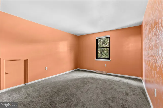 a bathroom with a toilet and a mirror