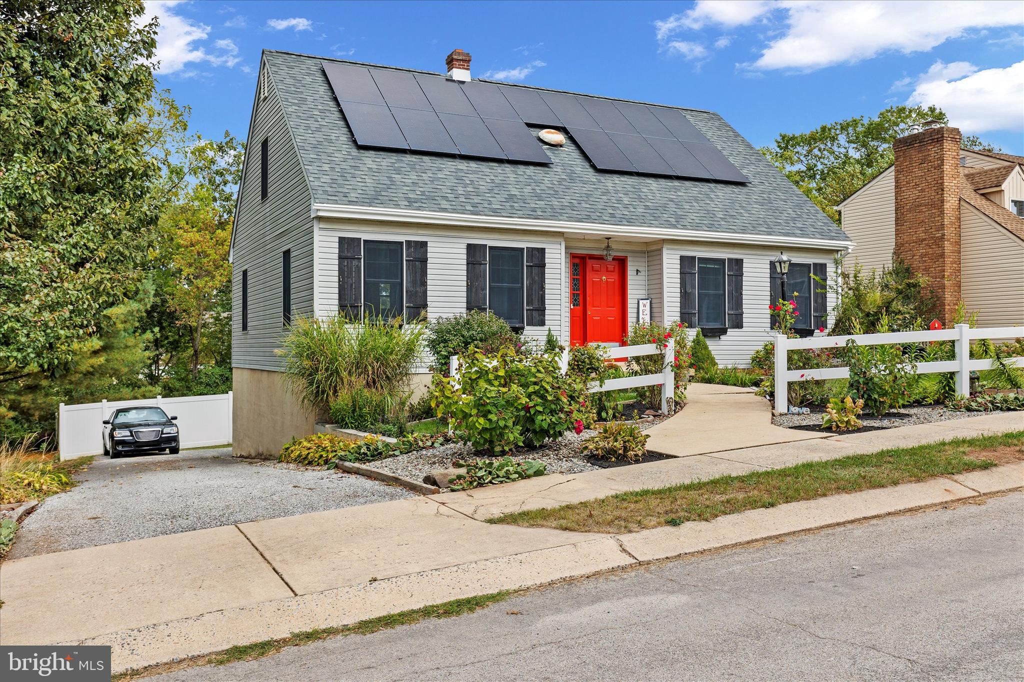 1769 Rainbow Circle York, PA 17408 - Photo 3 of 38 front view of a brick house with a bench in front of it