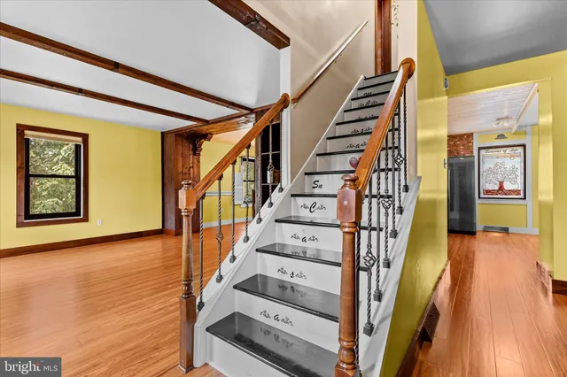 a view of empty room with wooden floor and fireplace