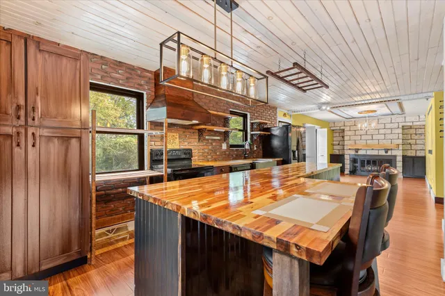 a kitchen with stainless steel appliances granite countertop sink stove and large window