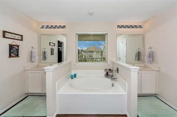 a white bath tub sitting next to a bathroom sink