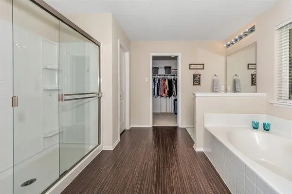 a bathroom with a bathtub and a shower