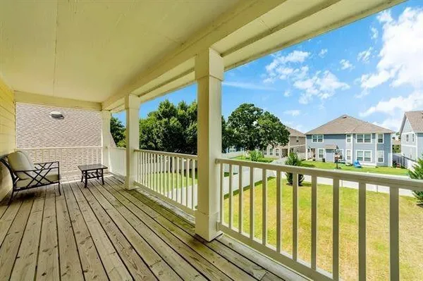 a view of balcony with wooden floor and outdoor seating