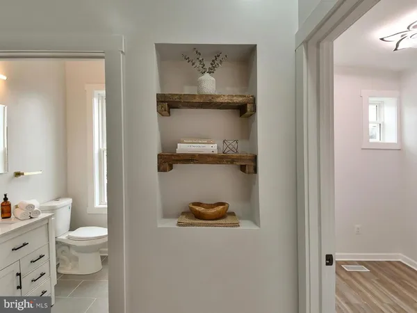 a view of a hallway with wooden floor