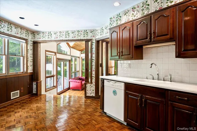 a view of a room with wooden floor and a window