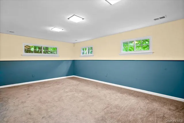 a view of a room with a wooden wall and a window