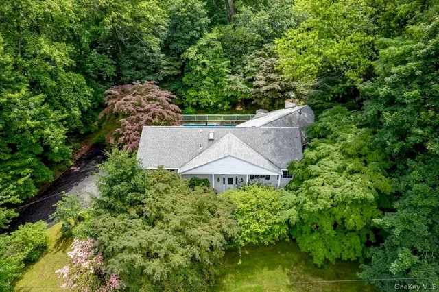 an aerial view of a house with yard and outdoor seating