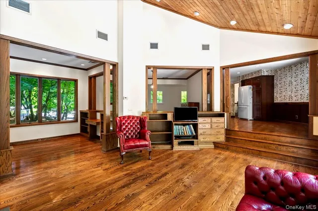 a spacious bedroom with a large window and a bed