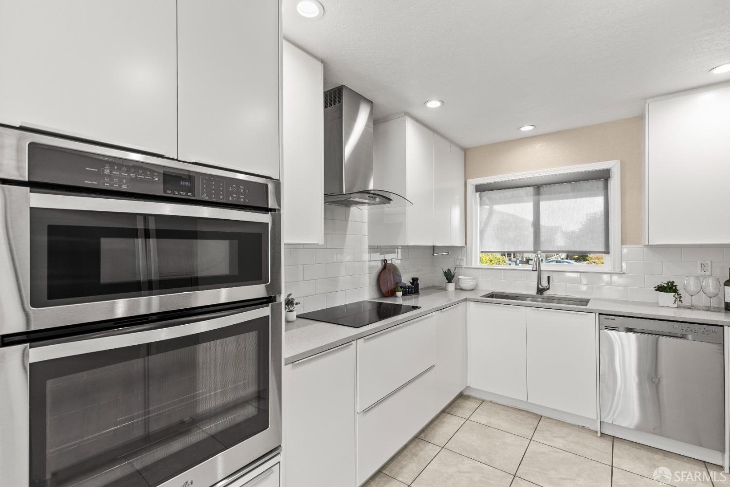 2445 Cabrillo Drive Hayward, CA 94545 - Photo 15 of 49 a kitchen with appliances a sink cabinets and a window