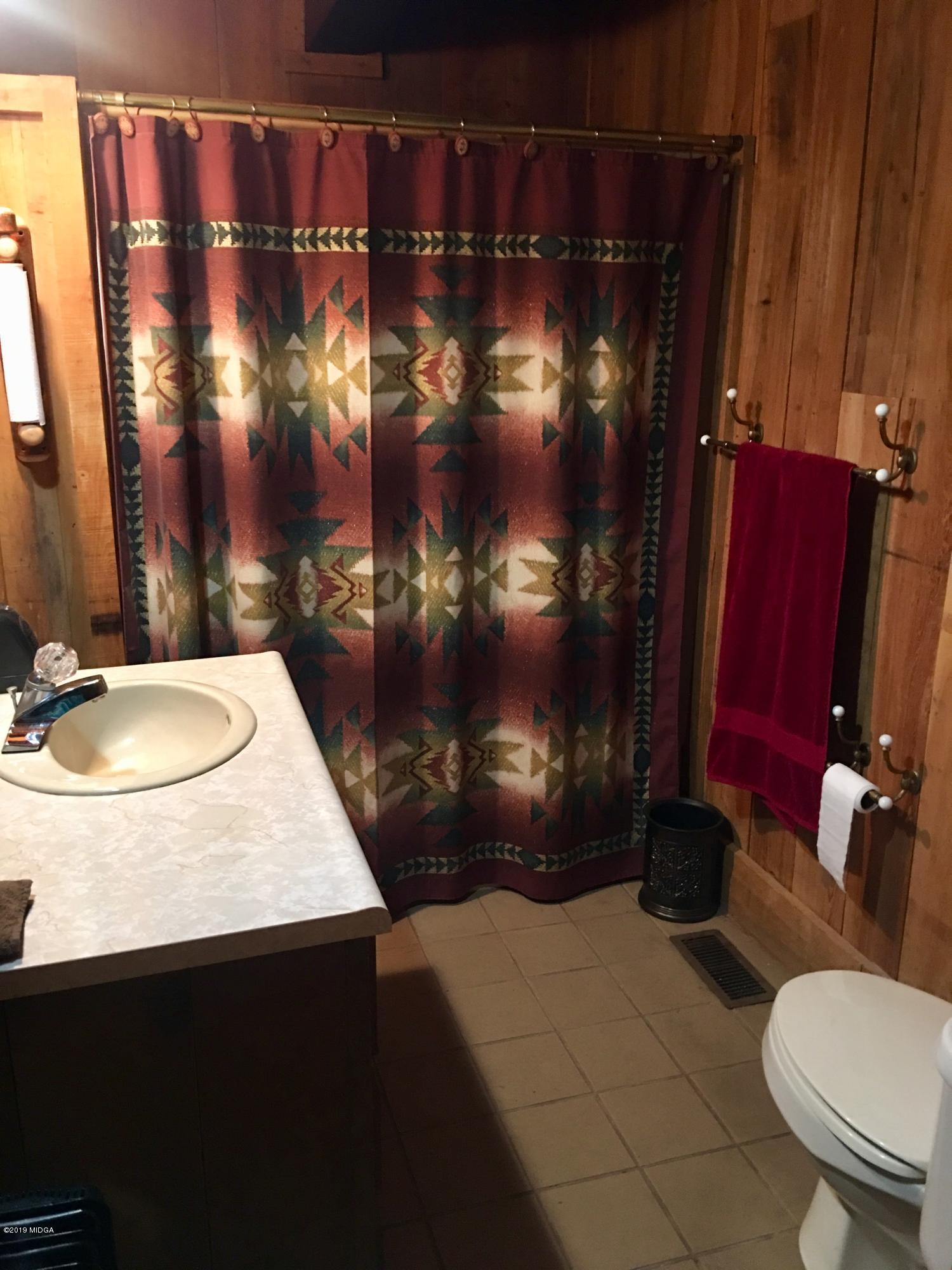 4155 Fulton Mill Road Macon, GA 31216 - Photo 17 of 20 a bathroom with a sink vanity mirror and toilet