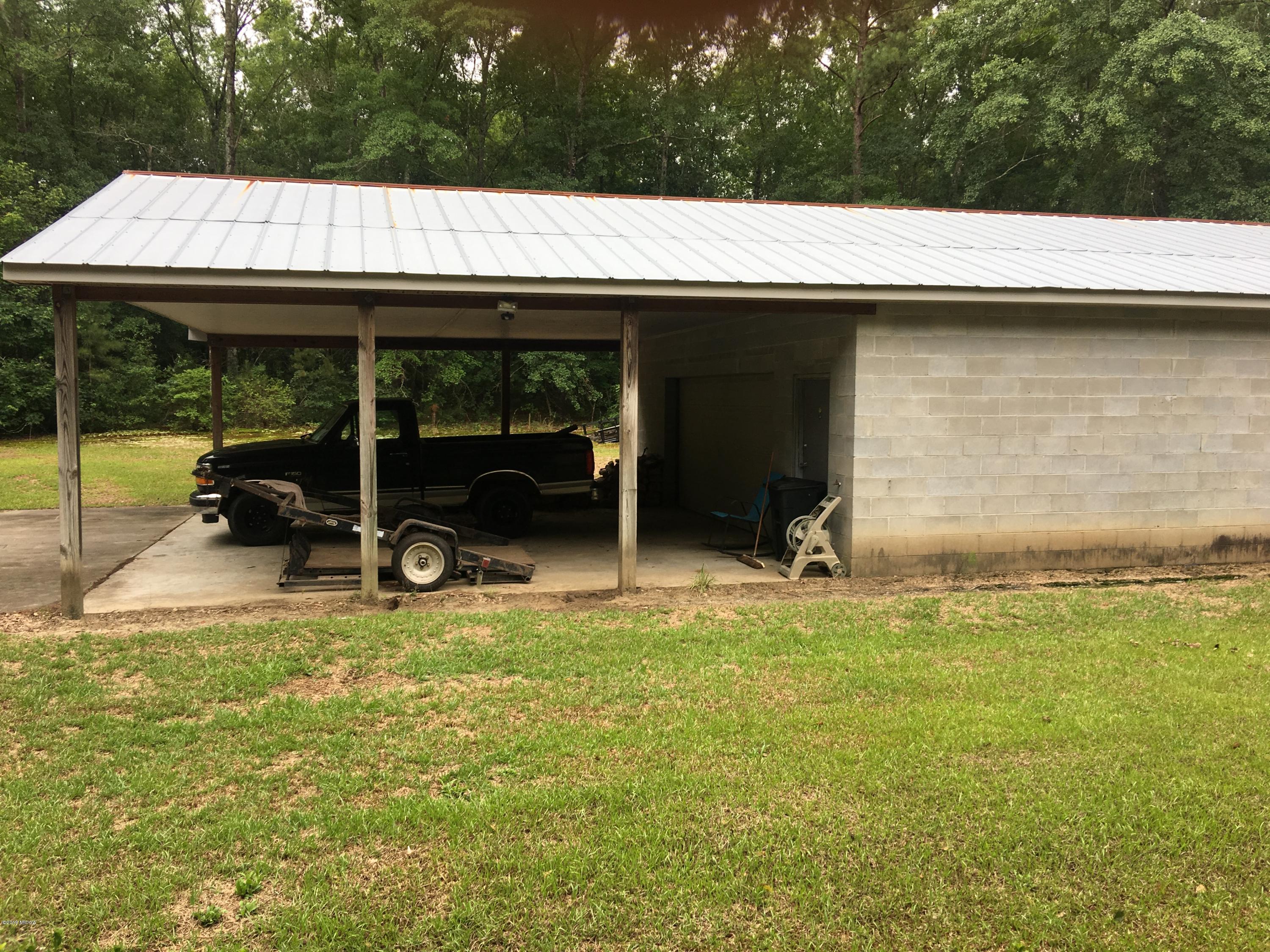 4155 Fulton Mill Road Macon, GA 31216 - Photo 18 of 20 a view of swimming pool with lawn chairs under an umbrella
