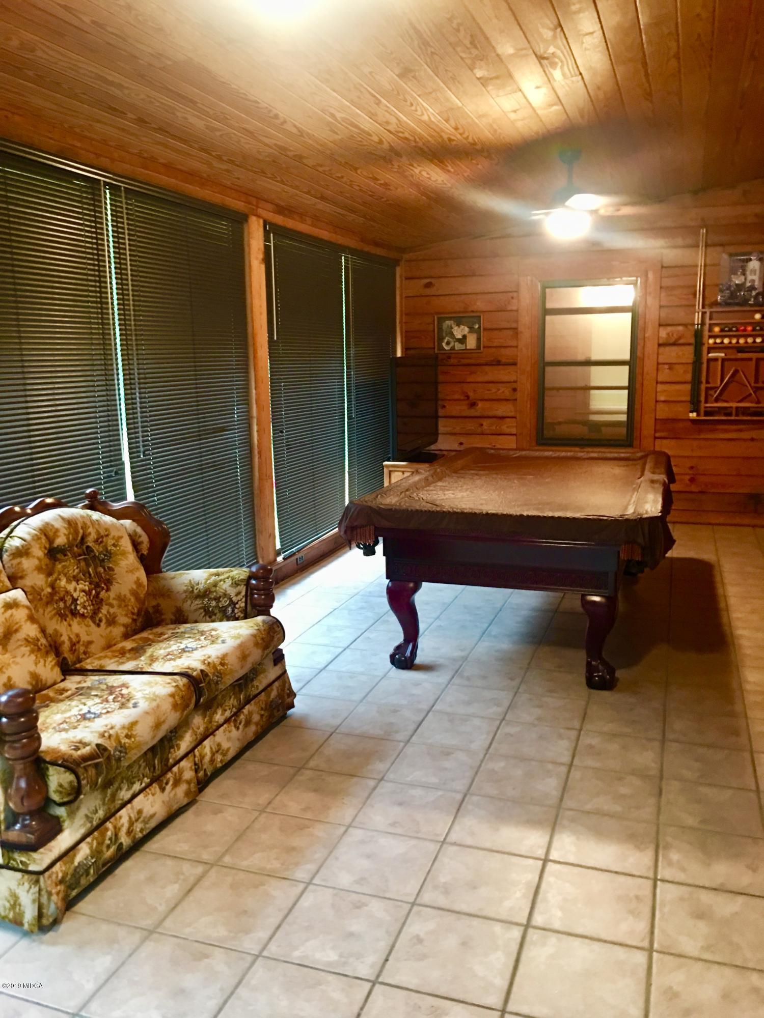 4155 Fulton Mill Road Macon, GA 31216 - Photo 7 of 20 a bedroom with furniture and a lamp
