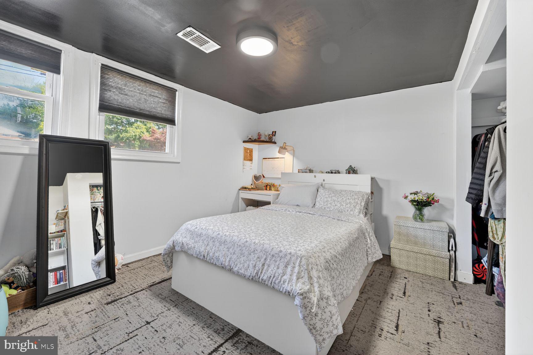 1104 Caddington Avenue Silver Spring, MD 20901 - Photo 22 of 35 a room with a bed mirror and a window
