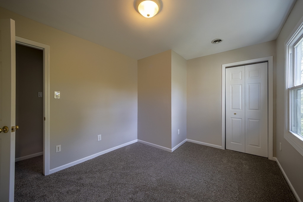 357 Boylston Street, Unit 3 Lowell, MA 01852 - Photo 16 of 35 an empty room with closet and mirror
