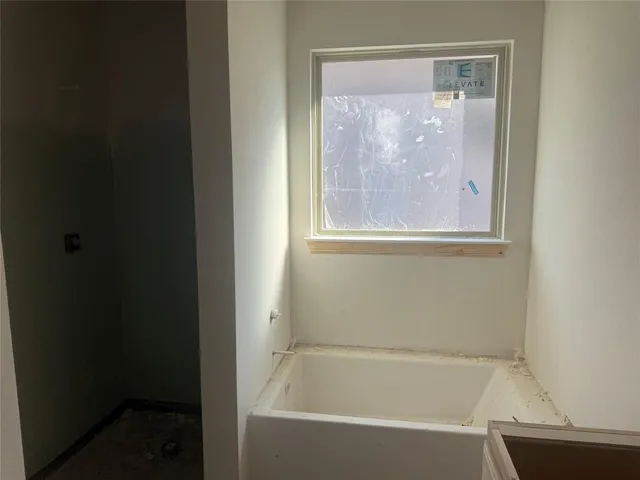a white bath tub sitting next to a shower