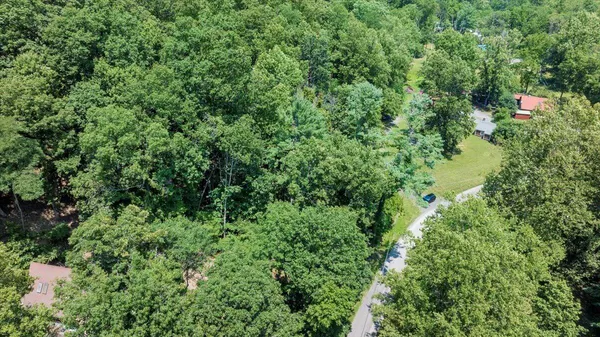 an aerial view of a house with a tree